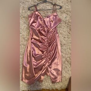 silky rose gold dress from honey and rosie with a slit and scrunched up.